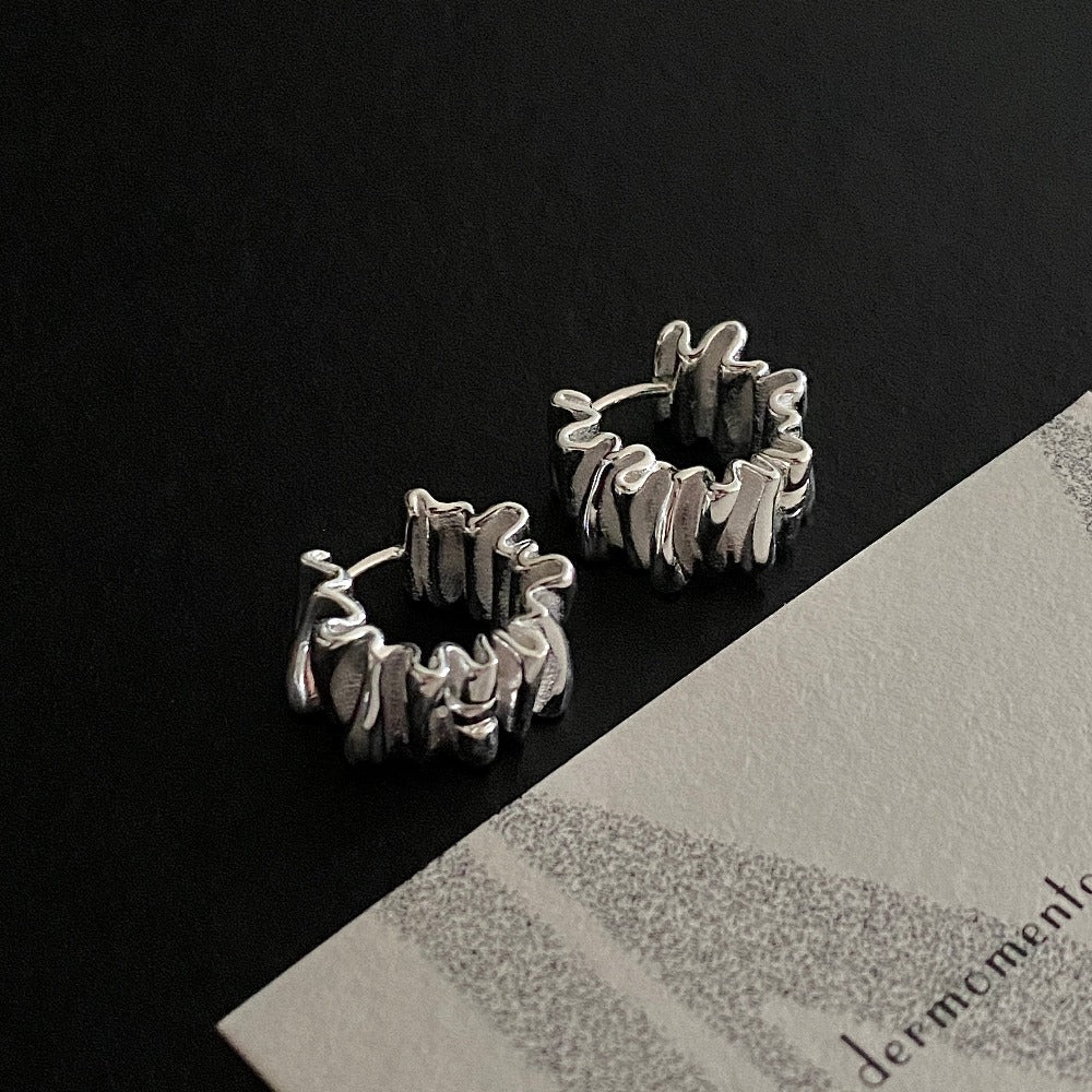 Anastasia Foil Pleat Hoop Earrings | dermomento.com - a balance of modern style and creative design. Crafted from sterling silver and boast a unique design with foil-like pleats that glint in the light for a touch of sparkle, perfect for any occasion.
