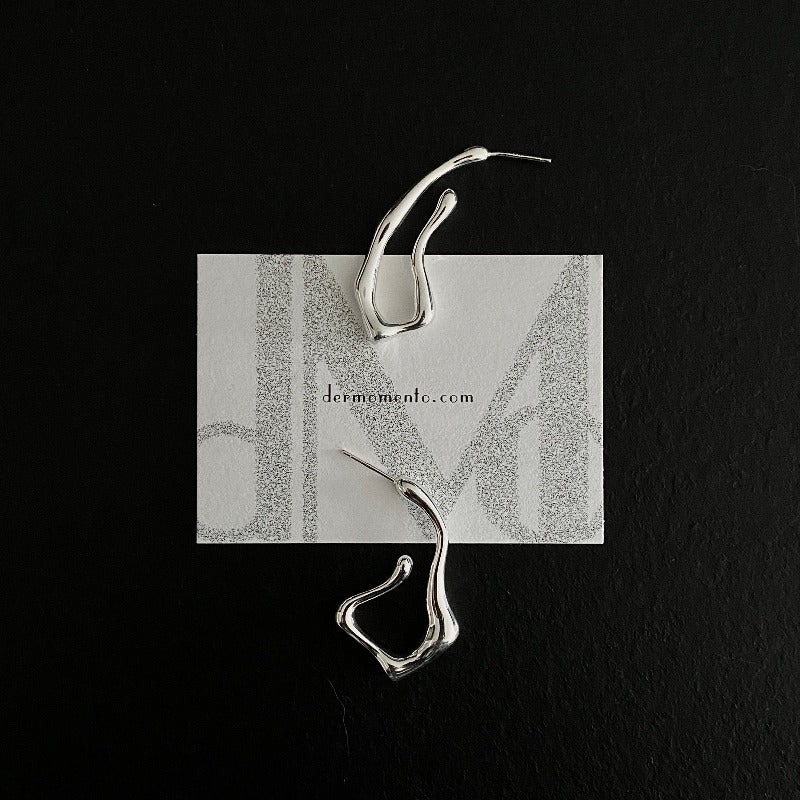 Squiggle-form earrings crafted in sterling silver, designed for a statement-making look that stands out.