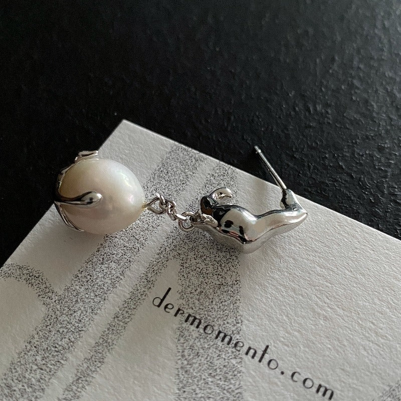 Baroque pearl drop earrings with claw form in sterling silver crafted with a white rhodium-plated finish.