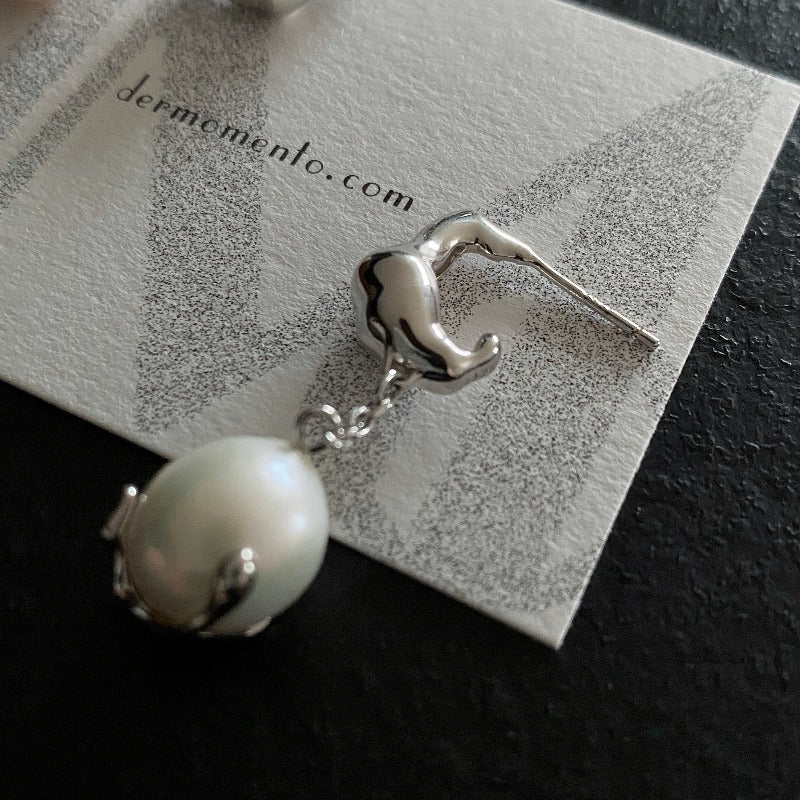 Baroque pearl drop earrings with claw form in sterling silver crafted with a white rhodium-plated finish.