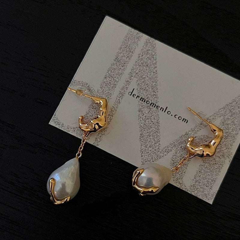 Natural baroque pearl drop earrings with claw form in sterling silver crafted with an 18-karat gold vermeil finish. A timeless classic with a modern edge, adds a perfect touch to any formal or special event.