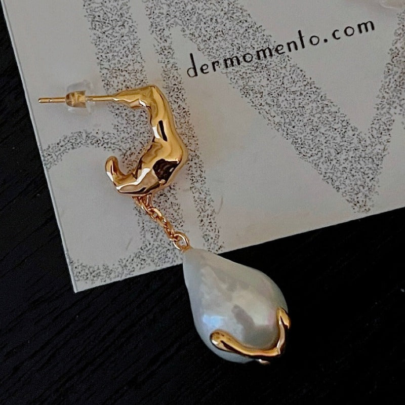 Natural baroque pearl drop earrings with claw form in sterling silver crafted with an 18-karat gold vermeil finish. A timeless classic with a modern edge, adds a perfect touch to any formal or special event.