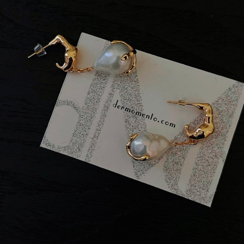 Natural baroque pearl drop earrings with claw form in sterling silver crafted with an 18-karat gold vermeil finish. A timeless classic with a modern edge, adds a perfect touch to any formal or special event.