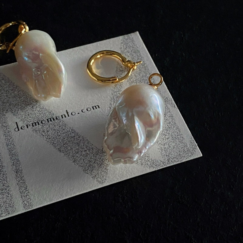 The Ariel Baroque Pearl Hoop Earrings feature a removable baroque pearl pendant paired with an 18-karat gold vermeil silver hoop. Both hoop and pearl pendant can be worn separately.