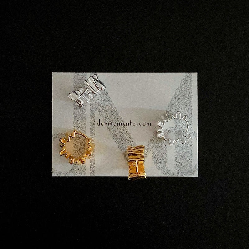 Two pairs of Anastasia Foil Pleat Hoop Earrings in 18k gold and silver color.
