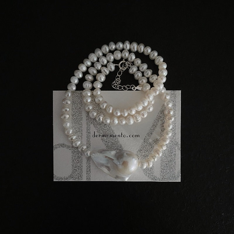 The Greta Pearl necklace is a stunning piece inspired by nature forms. Made with a large baroque pearl along with smaller freshwater pearls, all held together by a sterling silver clasp. The versatile design makes it suitable for all seasons, making it a must-have accessory for any fashion-forward individual.