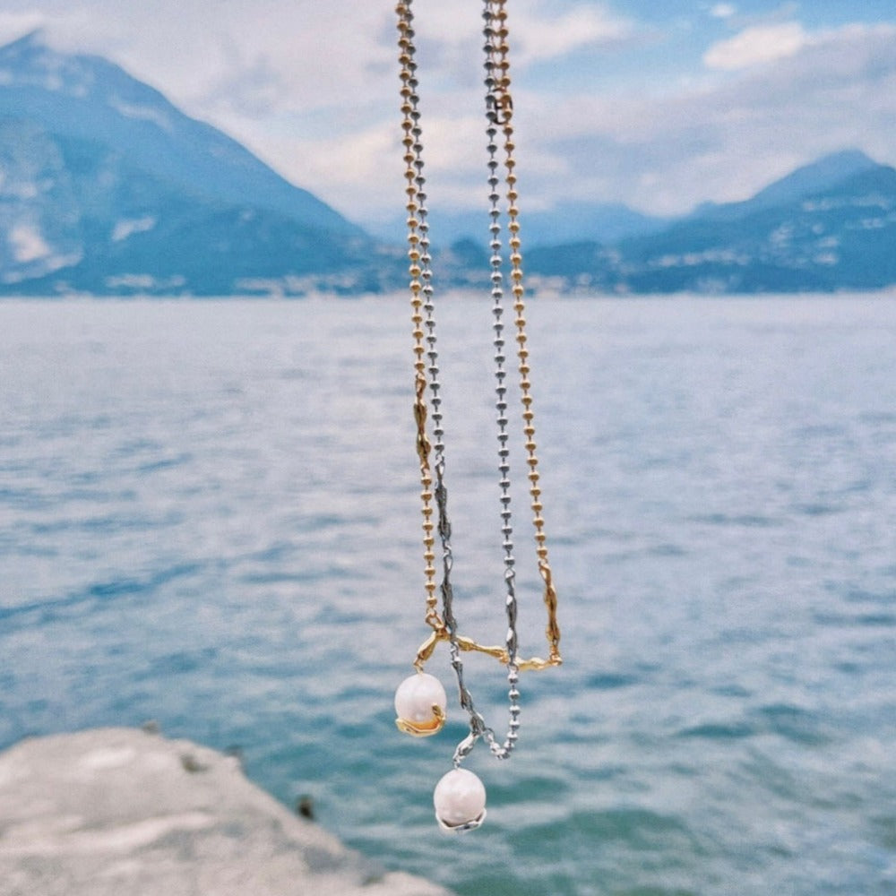 Baroque pearl pendant combined with claw-shaped irregular silver chain necklace, crafted in sterling silver with 18-karat gold vermeil finish.