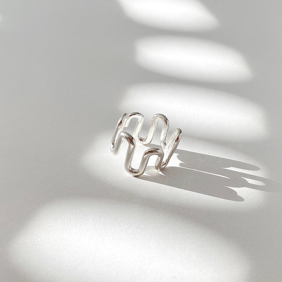 Crafted from sterling silver, this Wave Open Ring features an irregular yet chunky design that can be easily adjusted for the perfect fit.