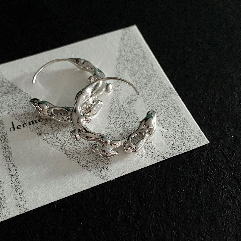 Natural elements-inspired flow hoop earrings, crafted from white rhodium-plated silver.