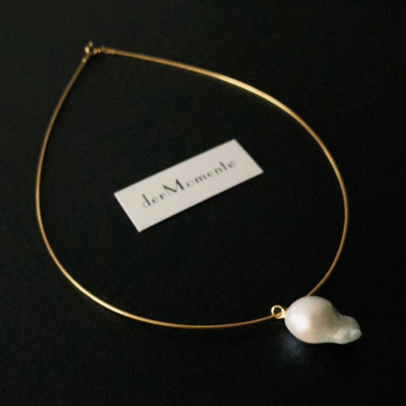 The Ariel Baroque Pearl Collar Choker Necklace with an inverted natural baroque pearl pendant on an 18-karat gold vermeil silver collar choker.