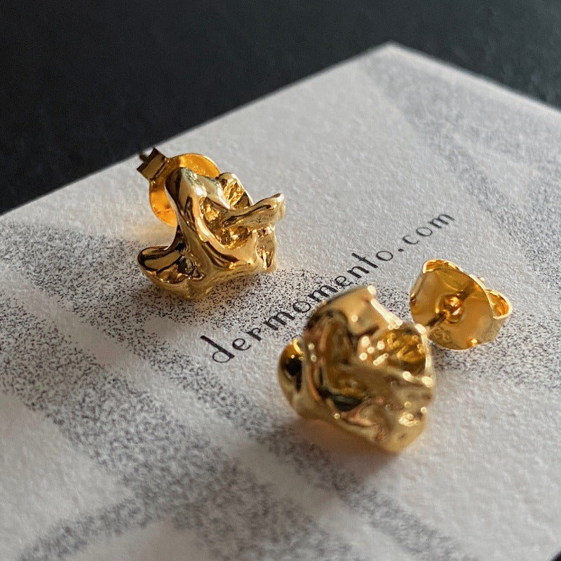 Molten Stud Earrings: Made from 18-karat gold vermeil silver, these molten stud earrings feature intricate details and textured folds that give them a unique and bold design.