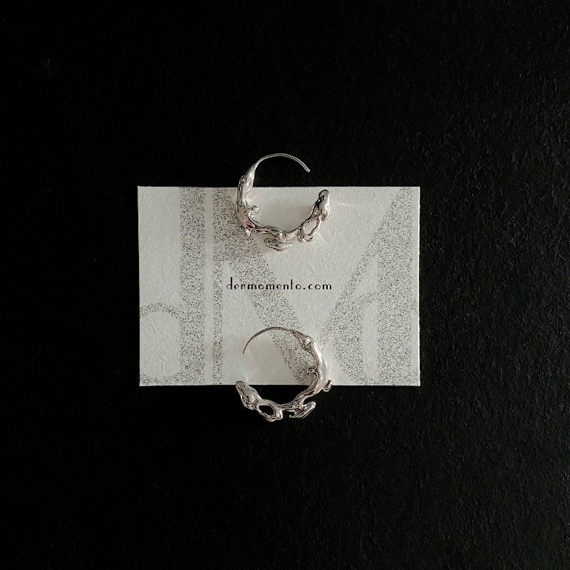 Natural elements-inspired flow hoop earrings, crafted from white rhodium-plated silver.