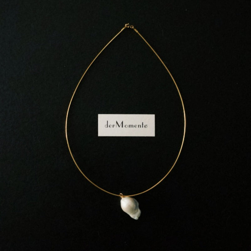 The Ariel Baroque Pearl Collar Necklace with an inverted natural baroque pearl pendant on an 18-karat gold vermeil silver collar choker.