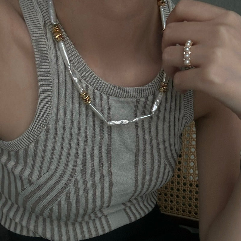The Clara Baroque Pearl Necklace features a unique, non-uniform shape of stick baroque pearls, accentuated by a magnetic clasp and irregularly placed 14K gold-plated brass details.