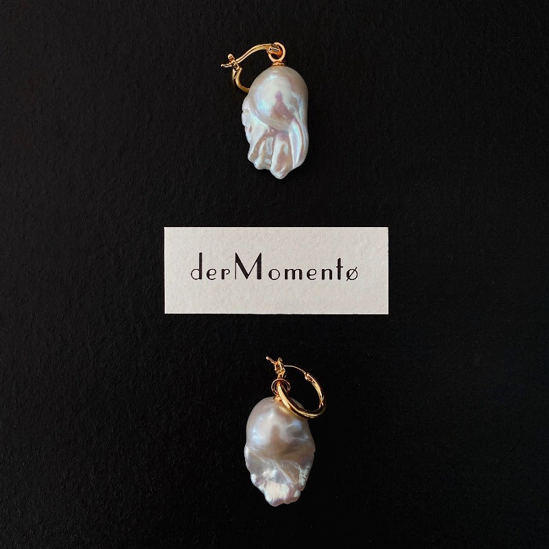 The Ariel Baroque Pearl Hoop Earrings feature a removable baroque pearl pendant paired with an 18-karat gold vermeil silver hoop.