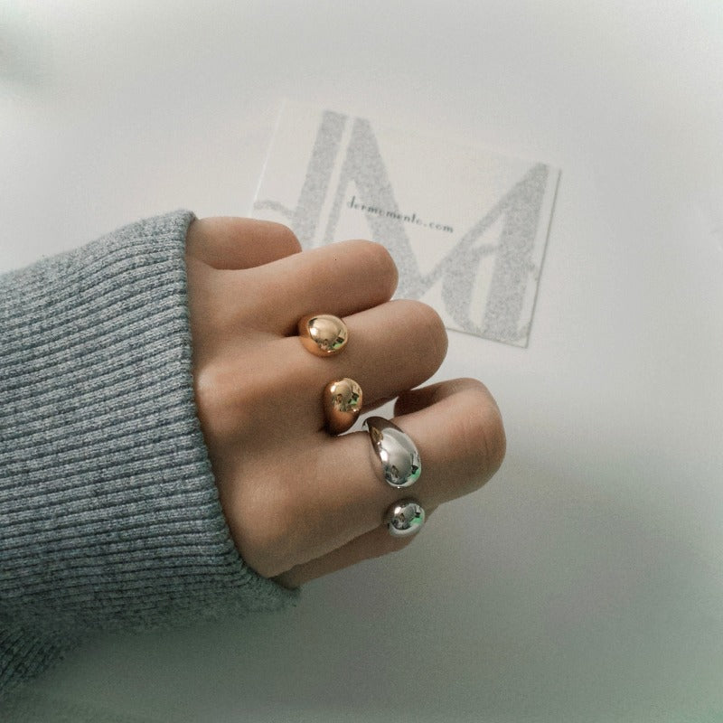 Crafted from white rhodium-plated silver for a classy yet versatile look. The chubby design balances between being eye-catching and understated. Open Adjustable.