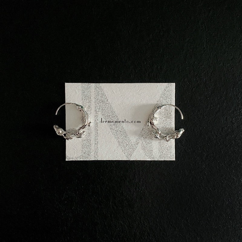Natural elements-inspired flow hoop earrings, crafted from white rhodium-plated silver.