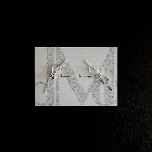 Amelia Ribbon Stud Earrings | dermomento.com – Bow-tie shaped stud earrings crafted from sterling silver flat snake chain material.