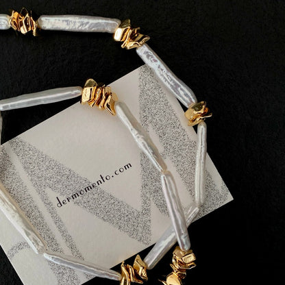 Close-up of elongated freshwater stick baroque pearls on the CLARA necklace