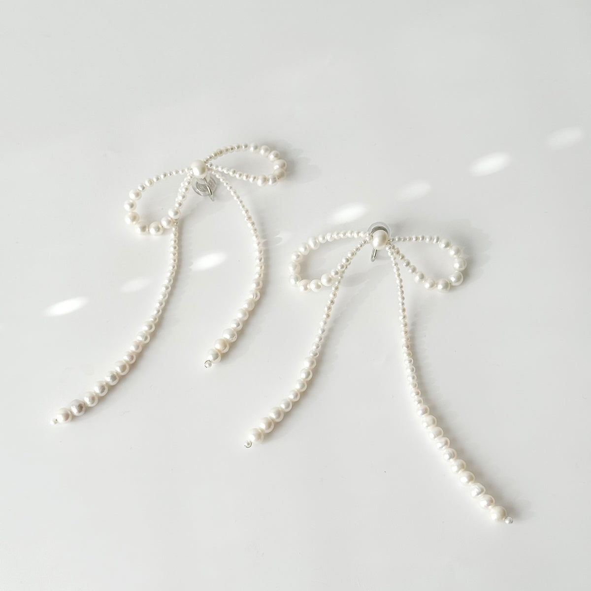 COLETTE oversized freshwater pearl bow earrings with long ribbon tails