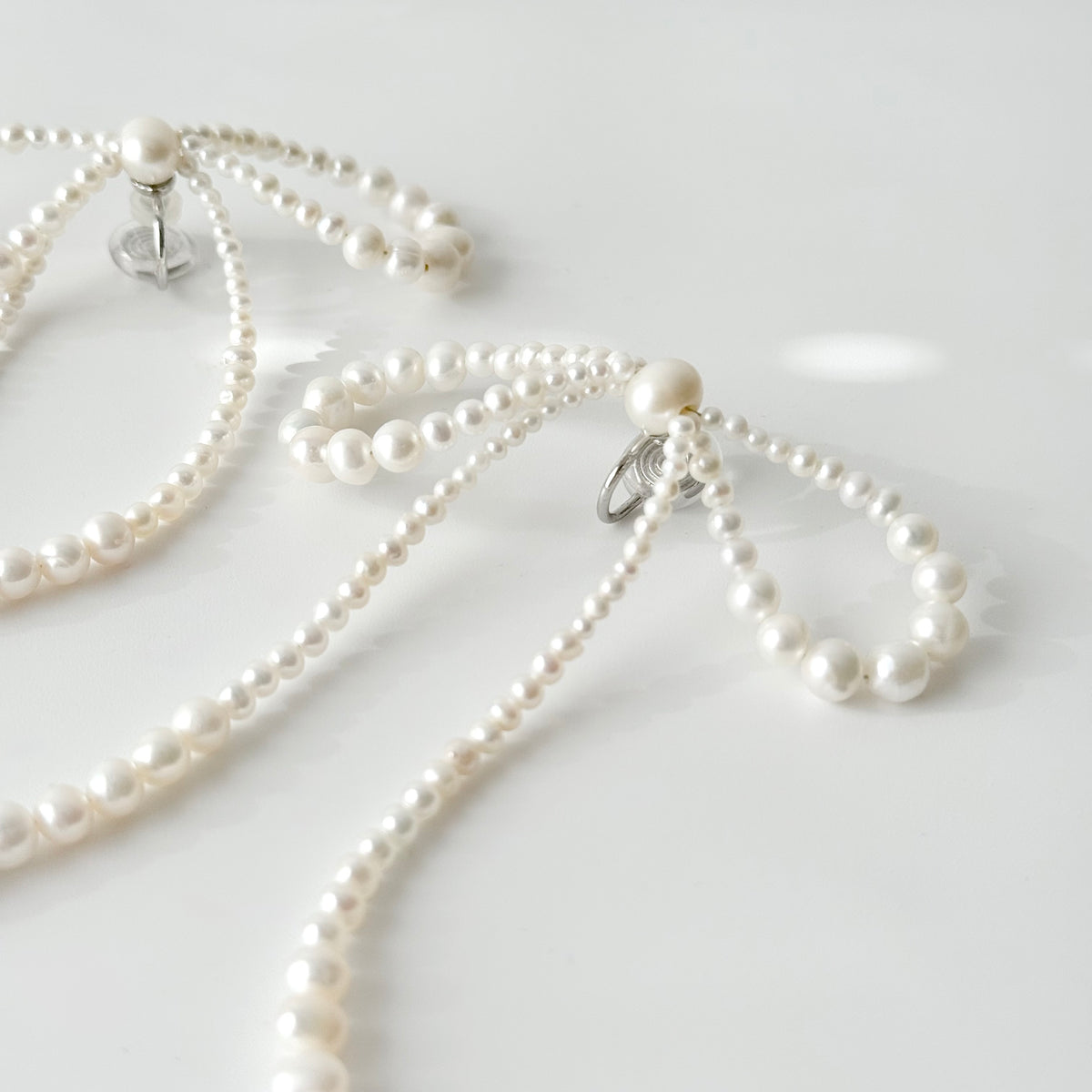 Pair of COLETTE freshwater pearl ribbon earrings with long pearl strands