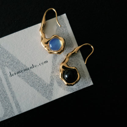 Close-up of HELENA earrings with rounded black onyx and blue opal settings