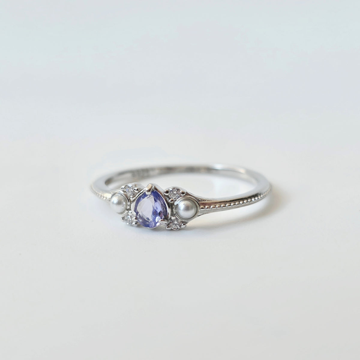 LINNIE tanzanite ring with pear-shaped purple gemstone and shell pearl accents