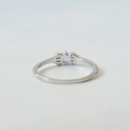 Detail of pear-shaped tanzanite and milgrain-style silver ring setting from back side