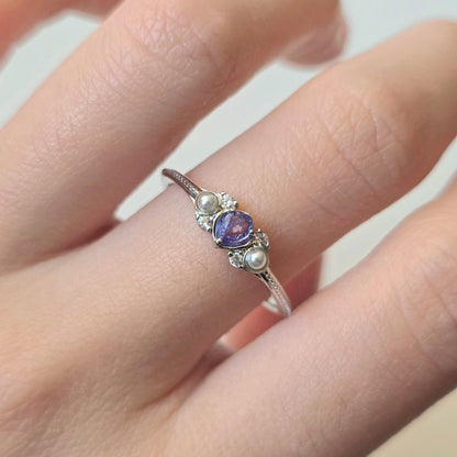 LINNIE sterling silver tanzanite ring worn on hand with shell pearls and cubic zirconia