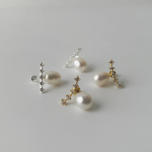 Close up of LYNN pearl stud earrings with oval pearls and angled zirconia rows