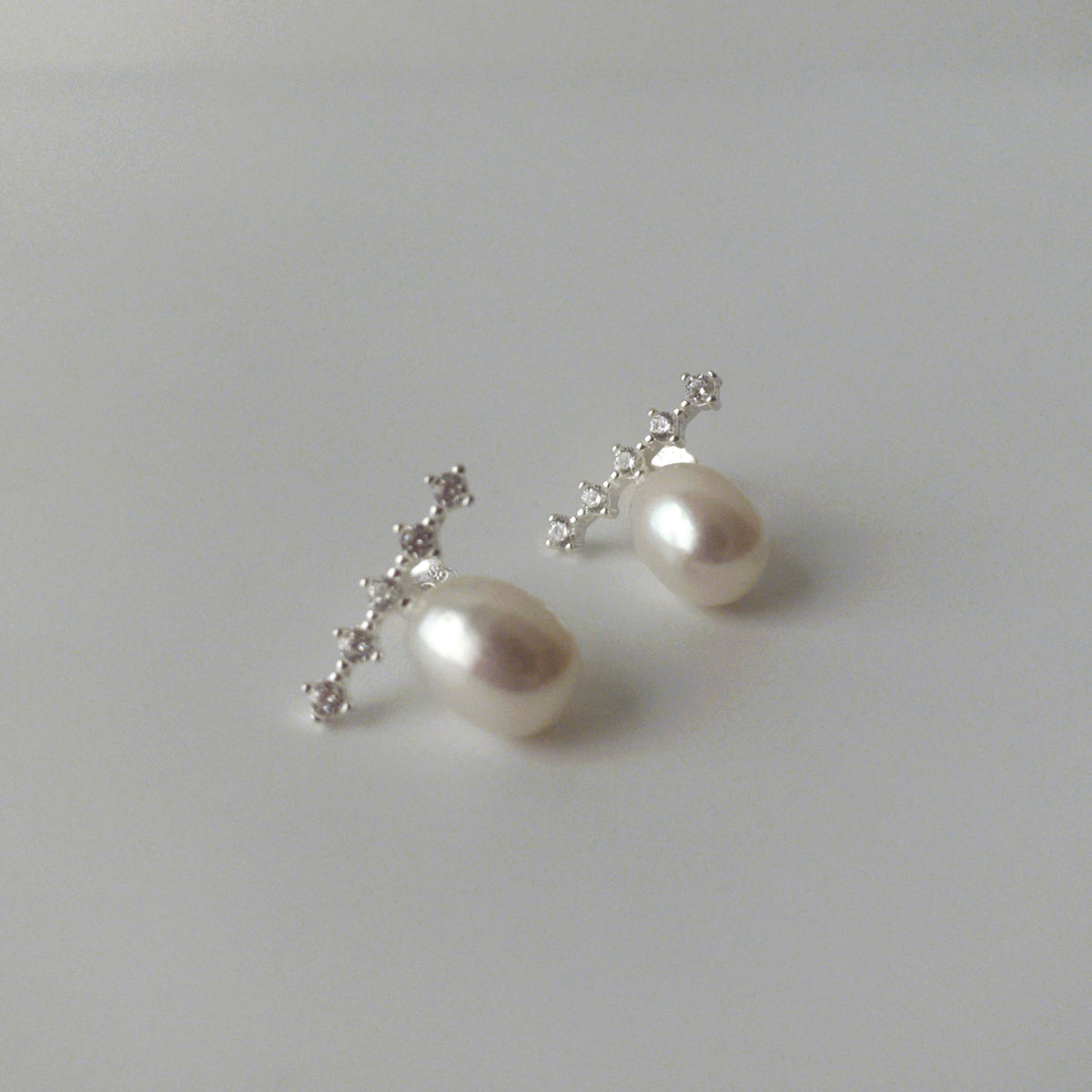 LYNN silver oval freshwater pearl stud earrings with diagonal zirconia accents