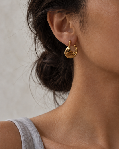 ASTRID sculptural gold hoop earrings worn on ear