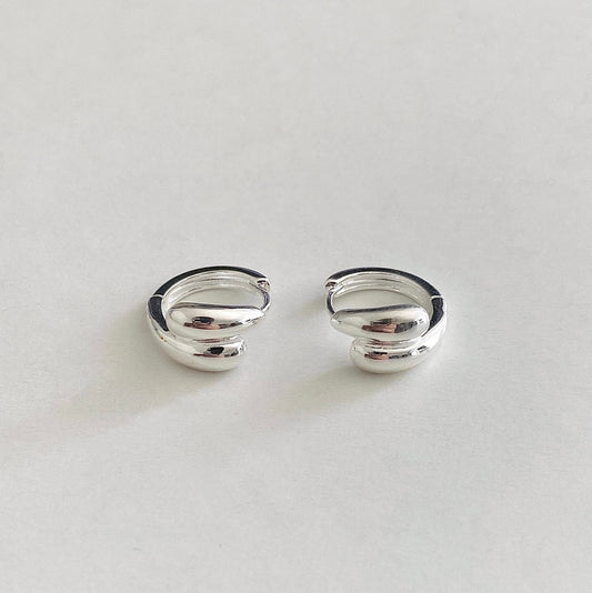 Double-crossed Drop Mini Huggies crafted in sterling silver, designed to be worn everyday with easy open and close hinged fastening.