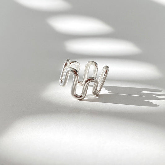 Crafted from sterling silver, this Wave Open Ring features an irregular yet chunky design that can be easily adjusted for the perfect fit.