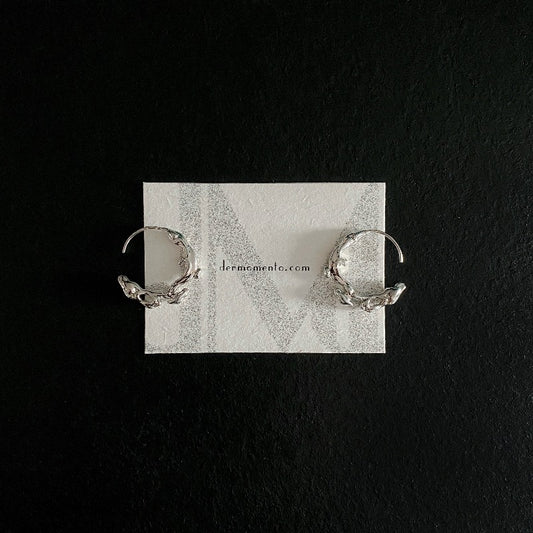 Natural elements-inspired flow hoop earrings, crafted from white rhodium-plated silver.