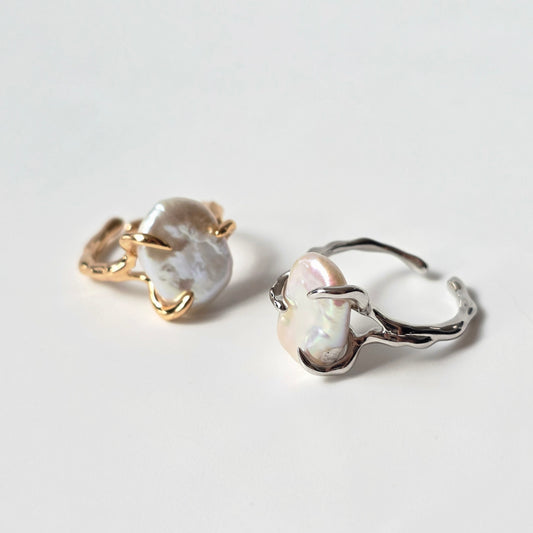 Sculptural sterling silver ring with curved prongs and flat baroque pearl