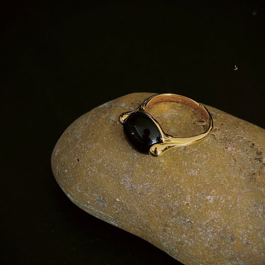 The Midnight Gemstone Ring expertly handcrafted in 18k gold vermeil silver, embellished with black onyx. This precious piece is designed to last and make a stunning statement with its unique combination of gold and onyx.