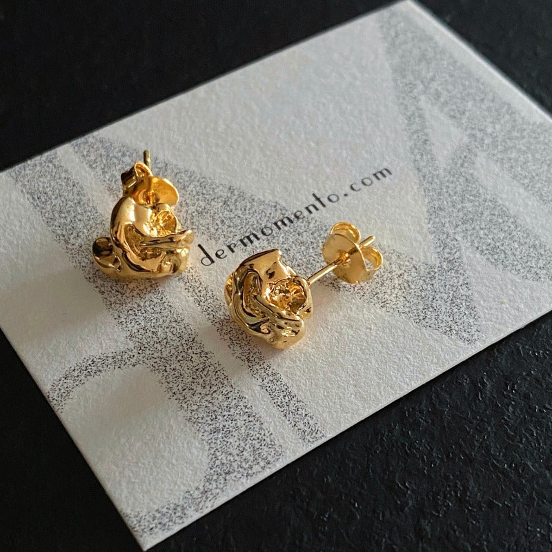 MOLTEN gold vermeil stud earrings with folded metal texture on derMomentø display card