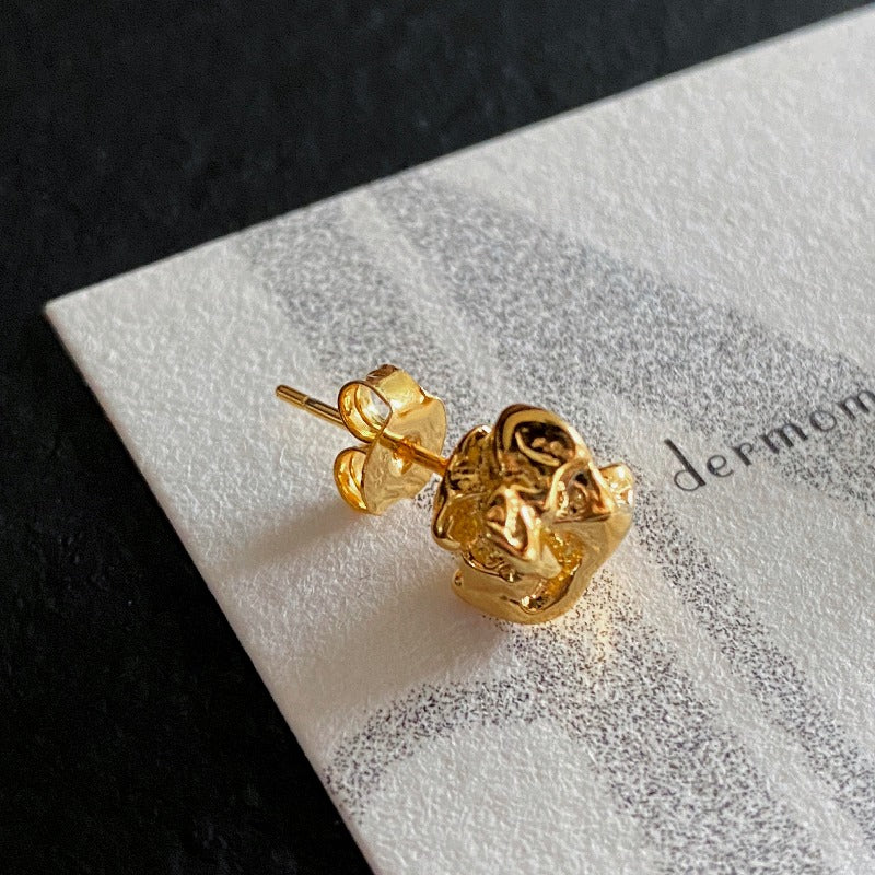 Small sculptural sterling silver stud earrings with molten gold vermeil finish