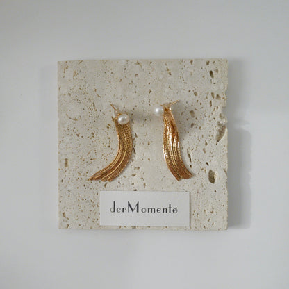 THEA freshwater pearl and gold chain tassel earrings displayed on stone