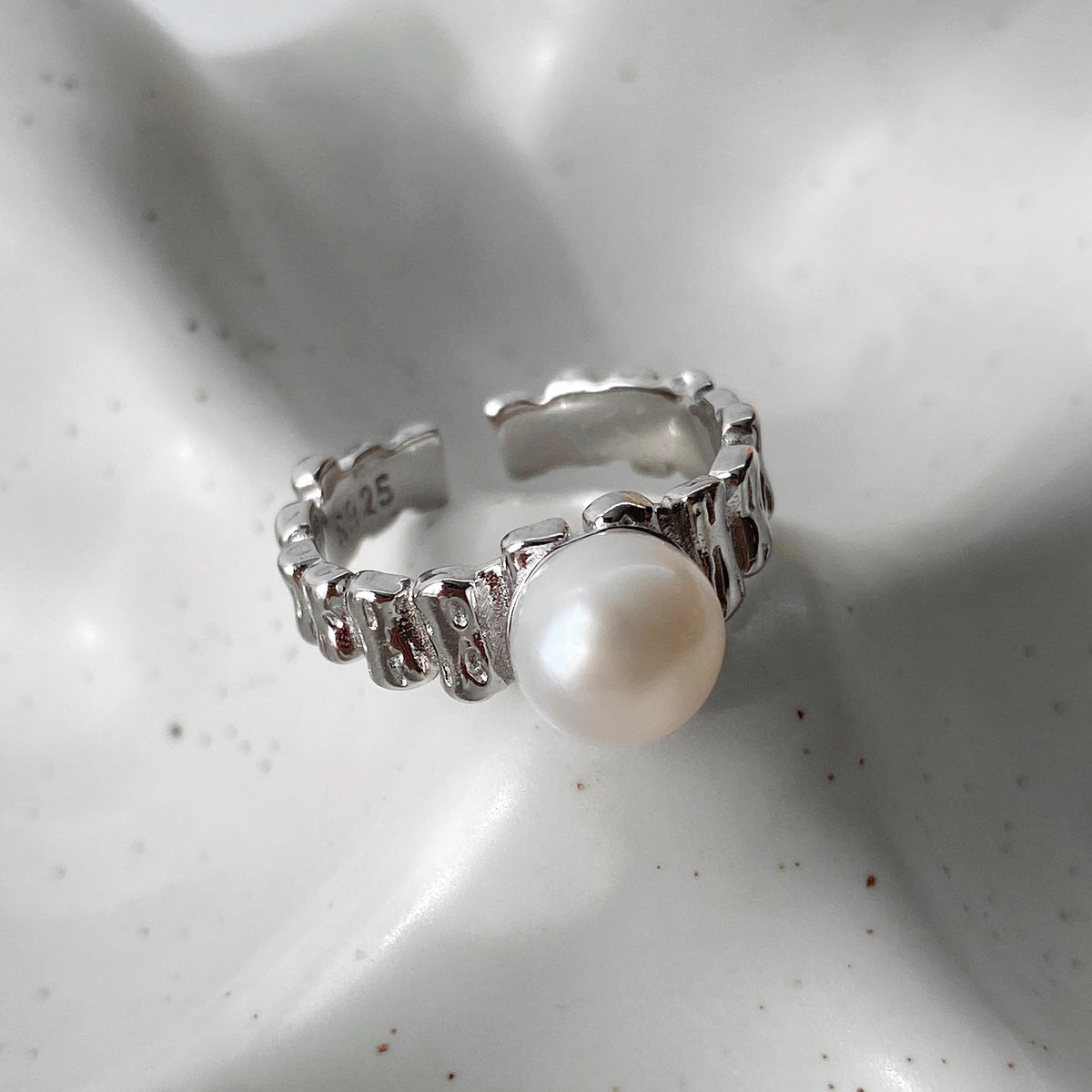 Single freshwater pearl set on an irregular sterling silver open band