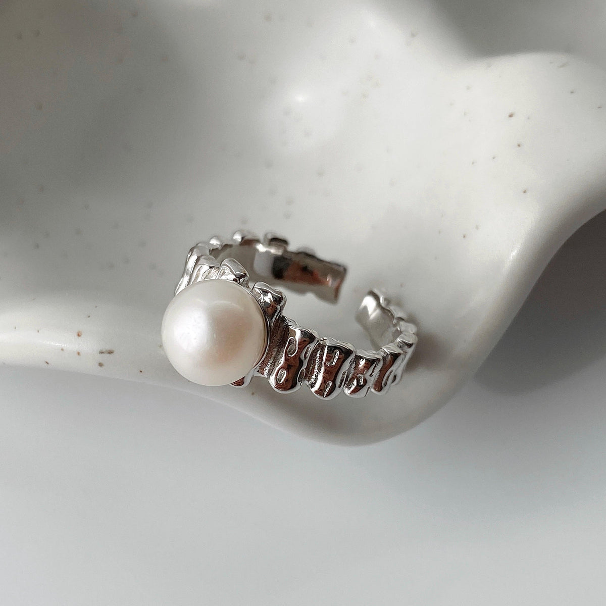 Textured sterling silver band on the VERENA pearl open ring